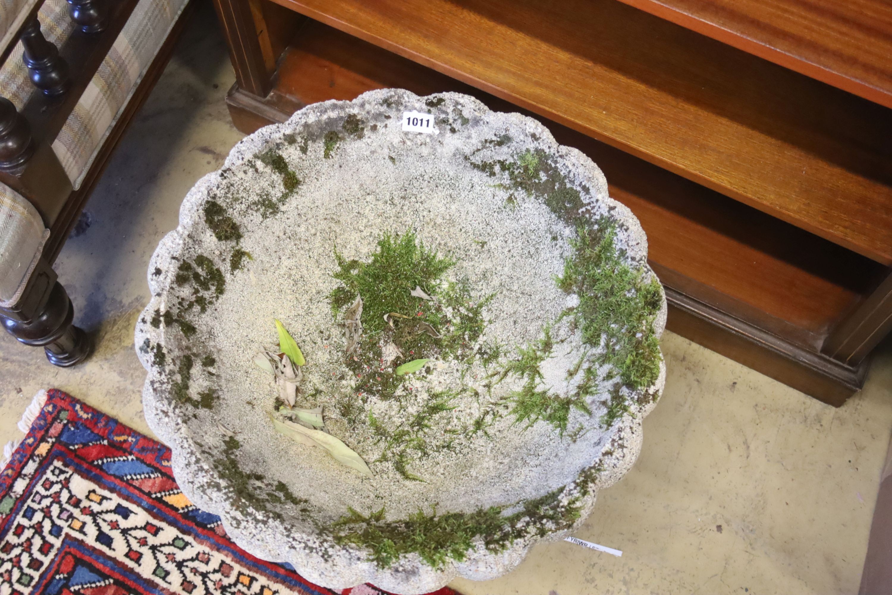 A circular reconstituted stone garden planter on stand, diameter 49cm, height 42cm
